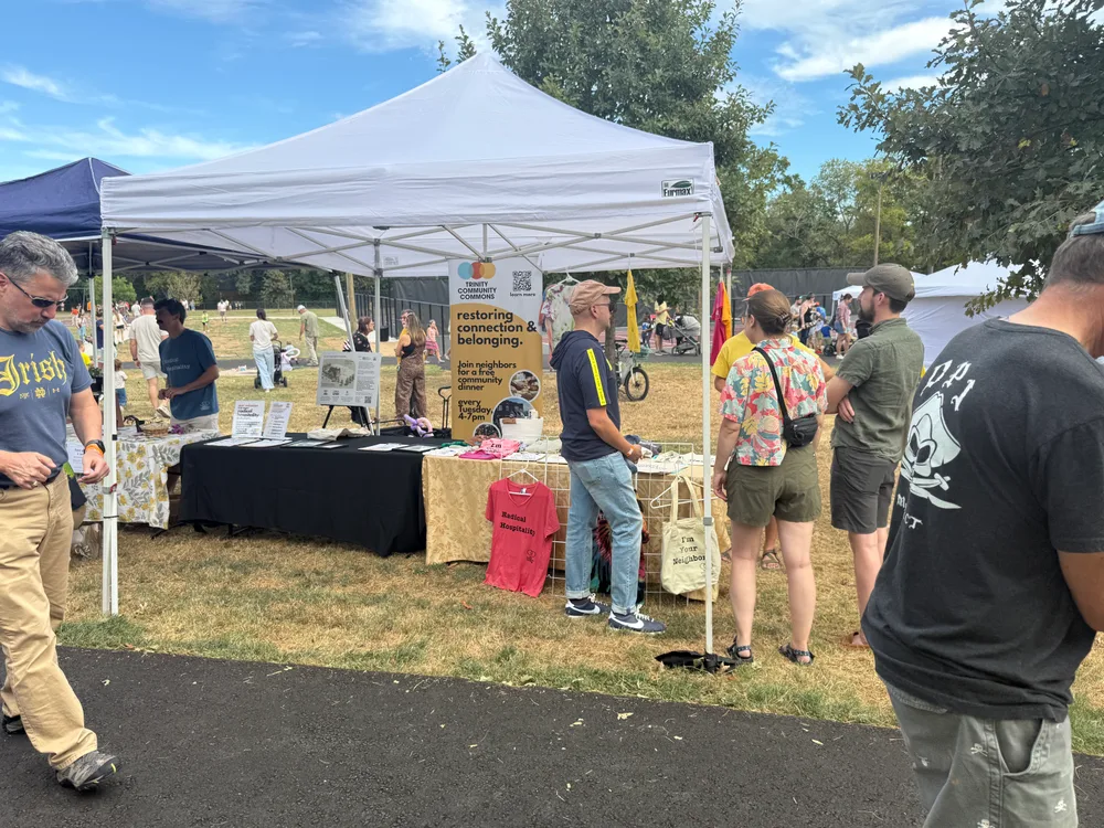 Neighbors visiting local businesses at the festival vendor tents.