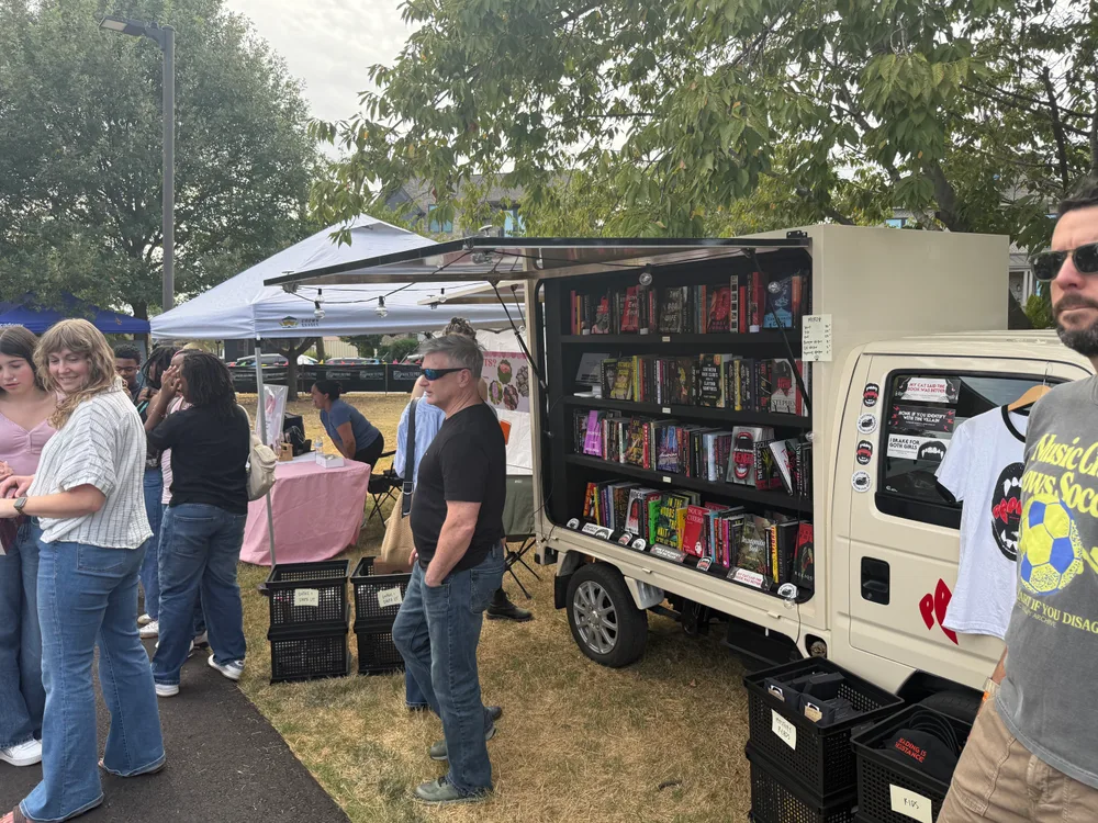 Festivalgoers browsing the Papercut Horror mobile bookshop.